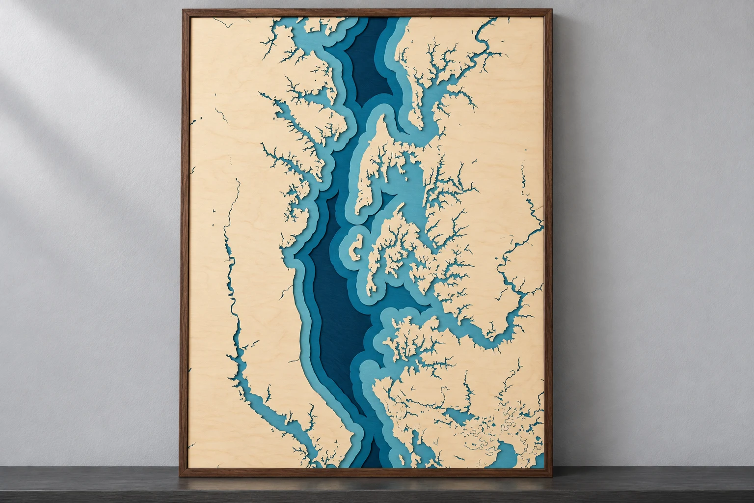 Simulated Chesapeake Bay layered wood map with blue shoreline terraces and a walnut border
